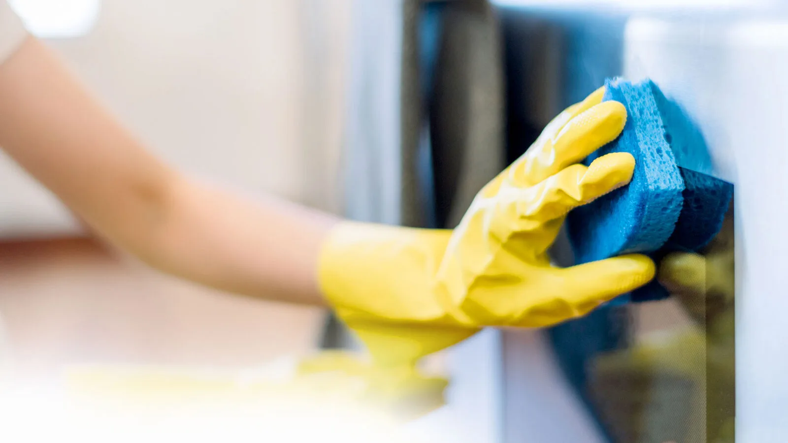 Cleaner wiping a glass surface